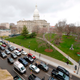 People in their vehicles protest against excessive quarantine orders from Michigan Governor Gretchen Whitmer around the Michigan State Capitol in Lansing, Michigan on April 15, 2020. - The protest was organized by Michiganders Against Excessive Quarantine several days after Michigan Governor Gretchen Whitmer extended her order through April 30 and took the requirements of staying home a step further, banning crossing the street to visit with neighbors or driving to see friends, among other things mandatory closure to curtail Covid-19.